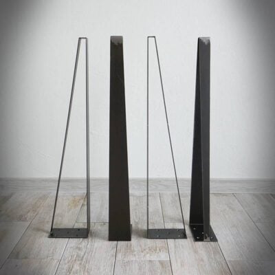 Fyra svarta metallbordben på trägolv