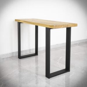 Träbord med svarta metallben på marmorgolv.