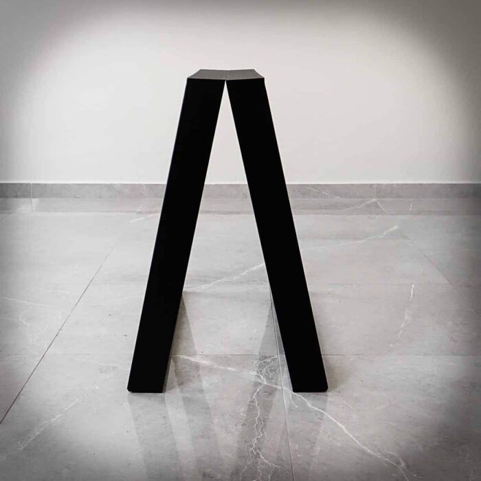 Bordsben-TILT-17 Svart, V-format föremål på grått golv.