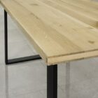 Träbord med metallben på kaklat golv.