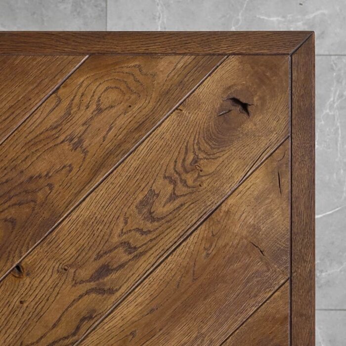 Fishbone-Grundoljad-Brun6.jpg Träbord med diagonalt mönster och kvistar.