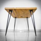 Modernt bord med metallben och träskiva.