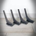 Fyra svarta metallfästen på golv.