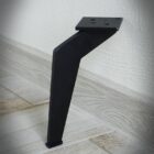 Svart metallben mot vägg på trägolv.