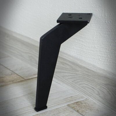 Svart metallben mot vägg på trägolv.